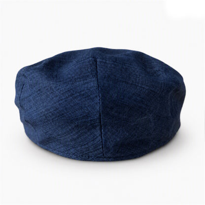 A dark navy blue textured fabric cap resting on a white background.