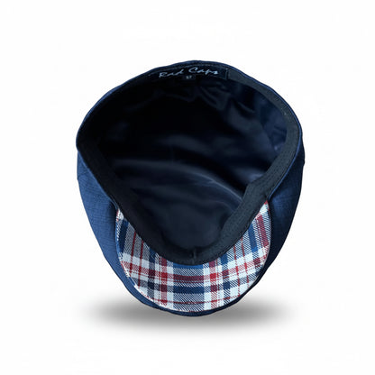 A navy blue hat with a red, white, and blue plaid pattern brim, shown from a top-down view on a white background