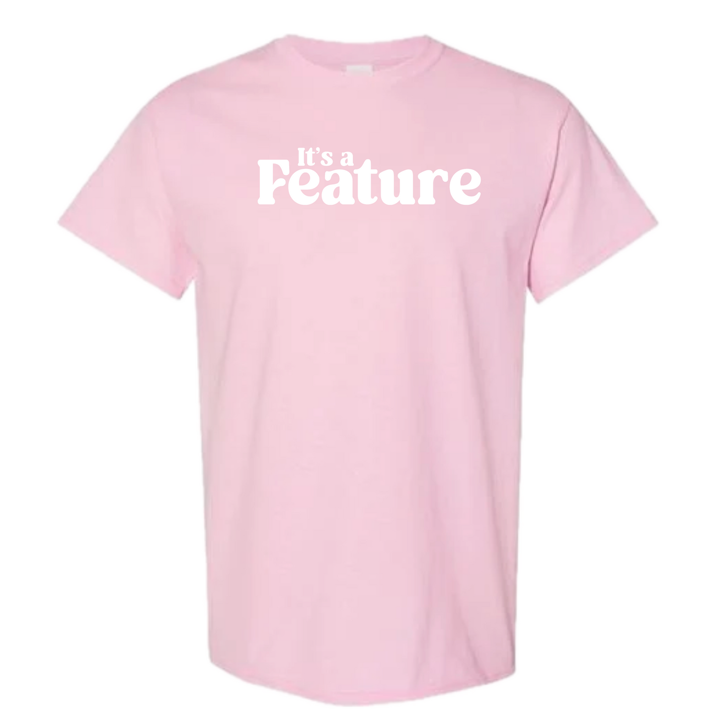 A light pink short-sleeve crewneck t-shirt with the phrase 'it's a Feature' printed in white across the chest, displayed on a solid white background.