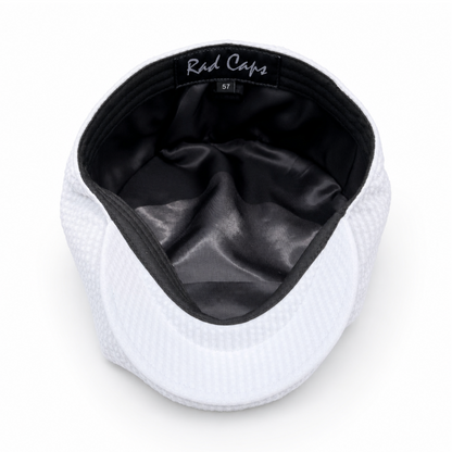 White cap with black interior on a white background
